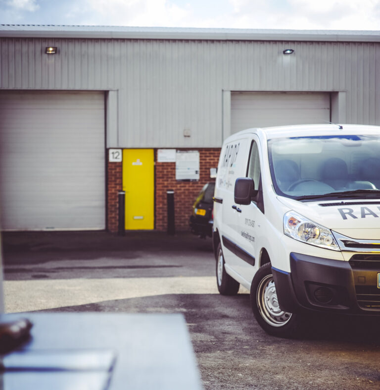 Image shows the outside of a warehoue, with a roller shutter door